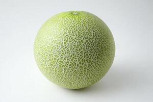 Cantaloupe Melon on White Background Displaying Textured Rind and Vibrant Color photo