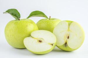 Fresh Green Apples Whole and Halved on a White Background Studio Shot photo