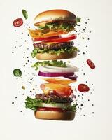 Exploded Burger with Fresh Ingredients and Floating Spices on White photo