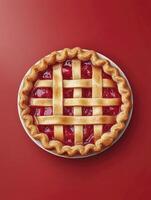 Homemade Cherry Pie with Lattice Crust on Red Background Overhead photo