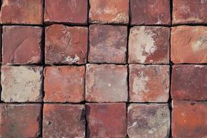 Arrangement of Square Red Bricks Creating Textured Wall Background photo