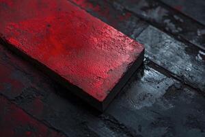 Textured Red Block on Dark Wood Background - Artistic Close Up photo
