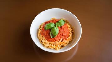 Spaghetti with tomato sauce and basil on brown background photo