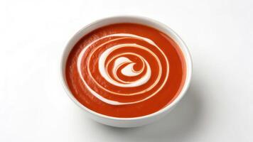 A bowl of tomato soup with a swirl of white cream photo