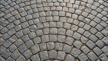 An image of a cobblestone road with a circular pattern photo