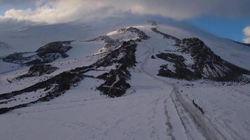 aerial view of a snowy route on Elbrus with climbers ascending the slope video