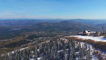 Aerial view of Sheregesh ski resort with first snow and mountain peaks video