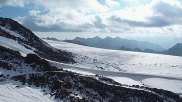 Expansive snowy landscape on Elbrus with distant mountain views video