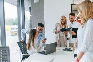 Conception of unity and teamwork... Group of professional business people is in the office photo