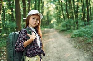 Portrait, of girl that is in the forest at summer day time discovering new places photo