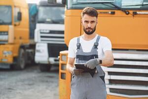 Man in unifrom doing service for big truck vehicle photo