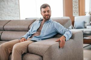 Sitting and enjoying. Customer visiting the sofa and bed store. Looking for update photo