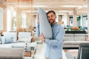 Embracing the pillow.. Customer visiting the sofa and bed store. Looking for update photo