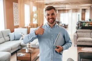 Friendly consultant is happy to see you in the sofa store photo