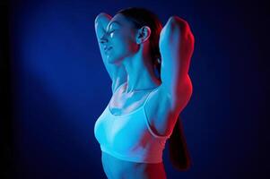 Feeling relaxed. Young ,woman in underwear is in the studio with neon lights photo