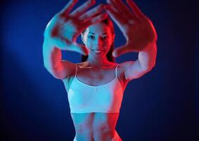 Doing, gestures by the hands. Young woman in underwear is in the studio with neon lights photo