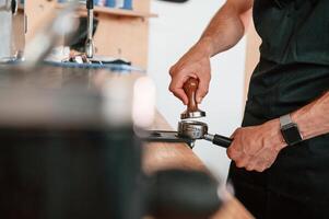Preparing,, coffee by special tool. Barista in the cafe. Close up view photo