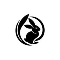 Silhouette of a stylized black rabbit within a circle and curved leaf, representing natures harmony and simplicity, on a white background. vector
