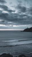 A lone lighthouse stands on the horizon in the distance photo