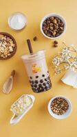 Boba bubble tea with nuts and nuts on yellow background photo