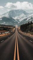 An empty highway with mountains in the background photo