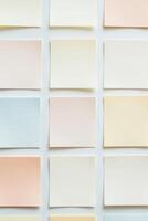 Many different colored post it notes arranged in a row photo