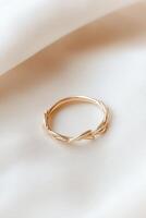 Elegant entwined thorns ring shines with simplicity against a minimalist backdrop photo