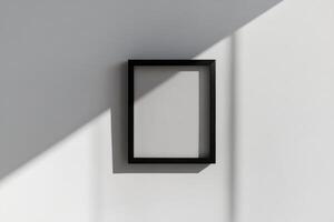 un negro cuadrado marco en un pared con un sombra foto