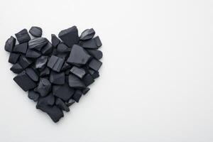 Creative heart shape made from artistic charcoal pieces arranged for minimalistic charm photo