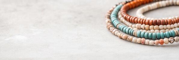 Colorful beaded anklets showcase unique patterns and textures against a minimal background for elegant styling photo