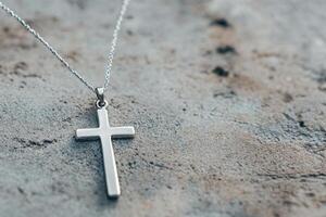 Intricate Gothic Silver Cross Pendant Showcasing Elegant Design Against Minimalistic Background photo