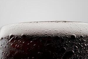 Professional stock photo of a frothy beer glass with bubbles captured on a white background