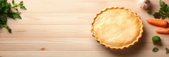 Golden chicken pot pie with flaky crust displayed on wooden table with fresh vegetables and herbs photo