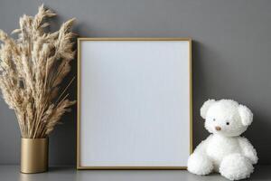 Elegant vertical gold frame with empty white canvas against smooth gray backdrop photo
