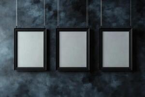 Modern poster frames suspended against a dark textured background in a studio setting photo