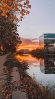 A building with a river and trees at sunset photo
