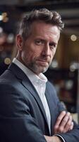 A man in a suit and tie standing in front of a bar photo