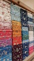 A display of colorful fabric in a store photo