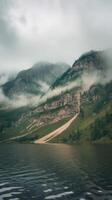 A lake surrounded by mountains and trees photo