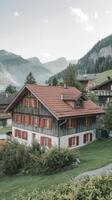 A house in the mountains with a red roof photo