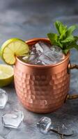 A copper mug with lime and mint leaves photo