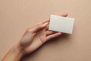 Minimalist Business Card Presentation with Elegant Hand on Neutral Background for Branding Concepts photo