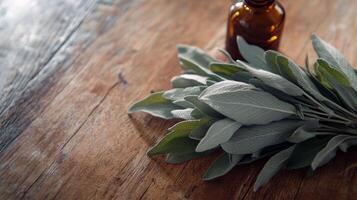 Fresh sage leaves and essential oil bottle on rustic wooden surface photo
