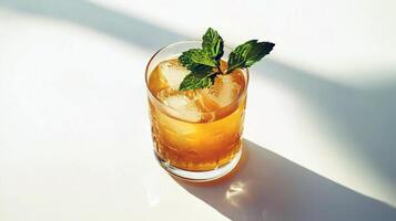 Refreshing iced tea with mint leaves in sunlit setting photo