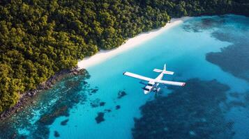 Seaplane flying over pristine blue waters near tropical beach and lush forest photo
