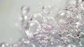 Close-up of clear water bubbles floating on light blue background photo
