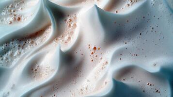 Close-up of creamy milk foam texture with bubbles and waves photo
