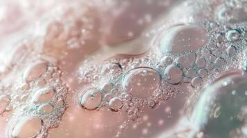 Close-up of pink soap bubbles with airy texture and light reflections photo