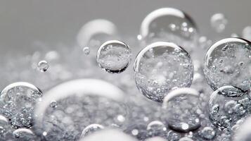 Close-up view of transparent bubbles floating on a soft blue background photo