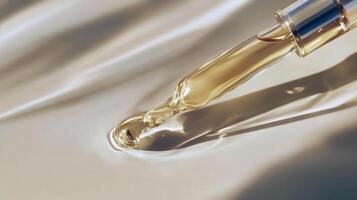 Golden liquid with dropper on smooth surface reflecting light photo